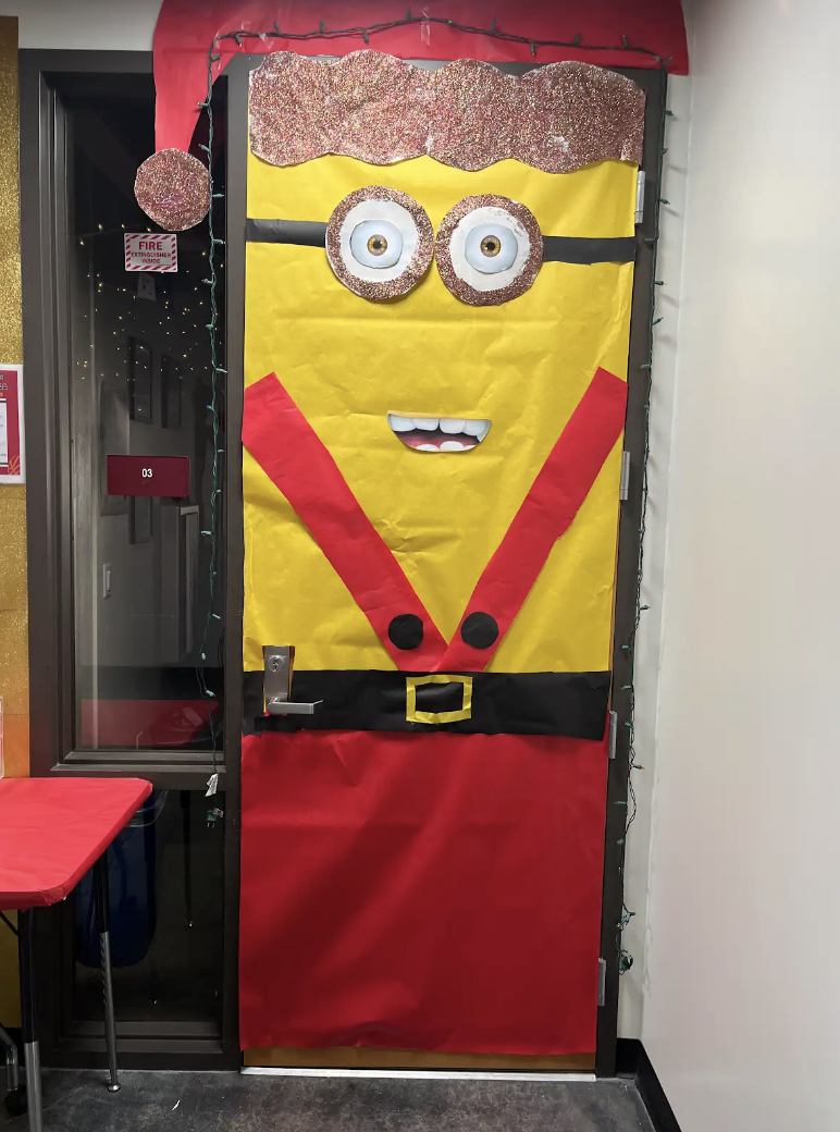 A holiday minion welcomes students entering the classroom. The door was decorated by English teacher Courtney Kun's first period class.